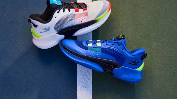 White and blue Skechers basketball shoes on an outdoor court.